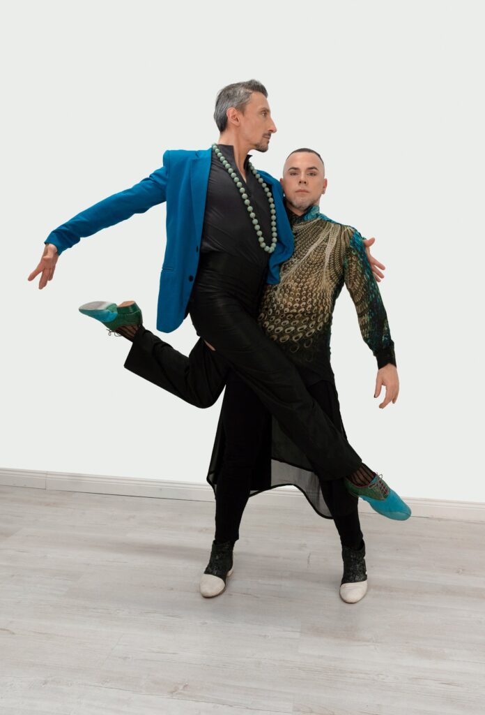 Martin Maldonado and Maurizio Ghella dancing on a pale studio ground, one in a teal brocade jacket.